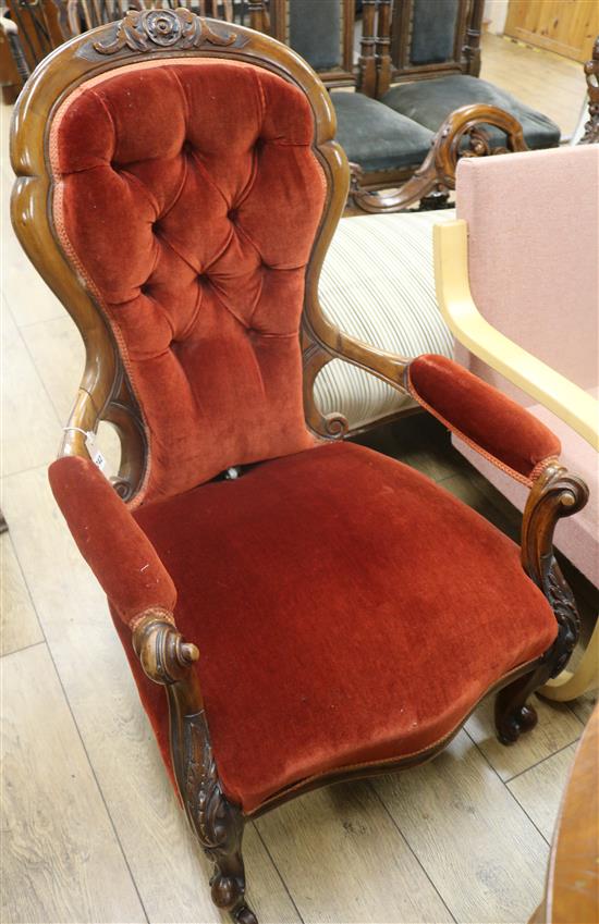A Victorian carved walnut open armchair